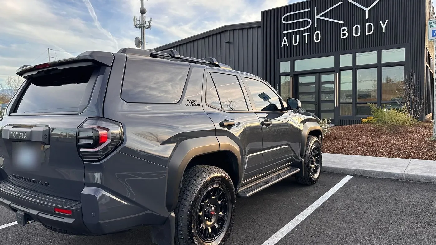The same gray Toyota 4Runner TRD Off-Road with the rear quarter panel repaired and refinished, parked outside Sky Auto Body